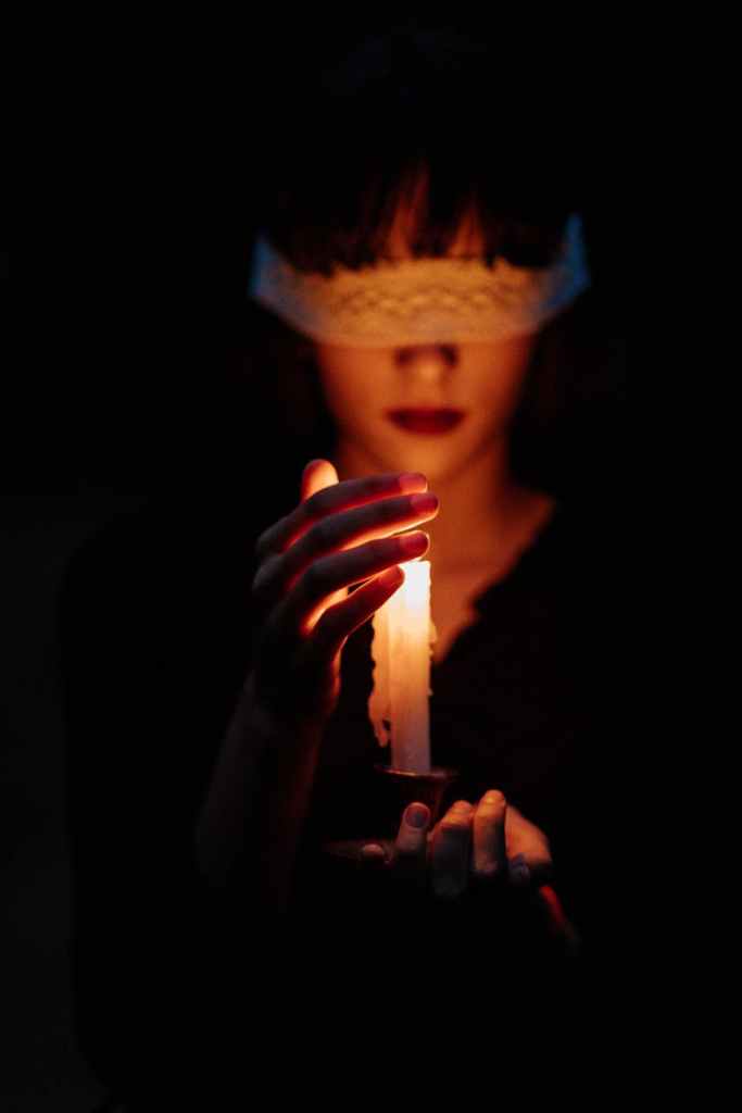 A bound witch follows the candle light